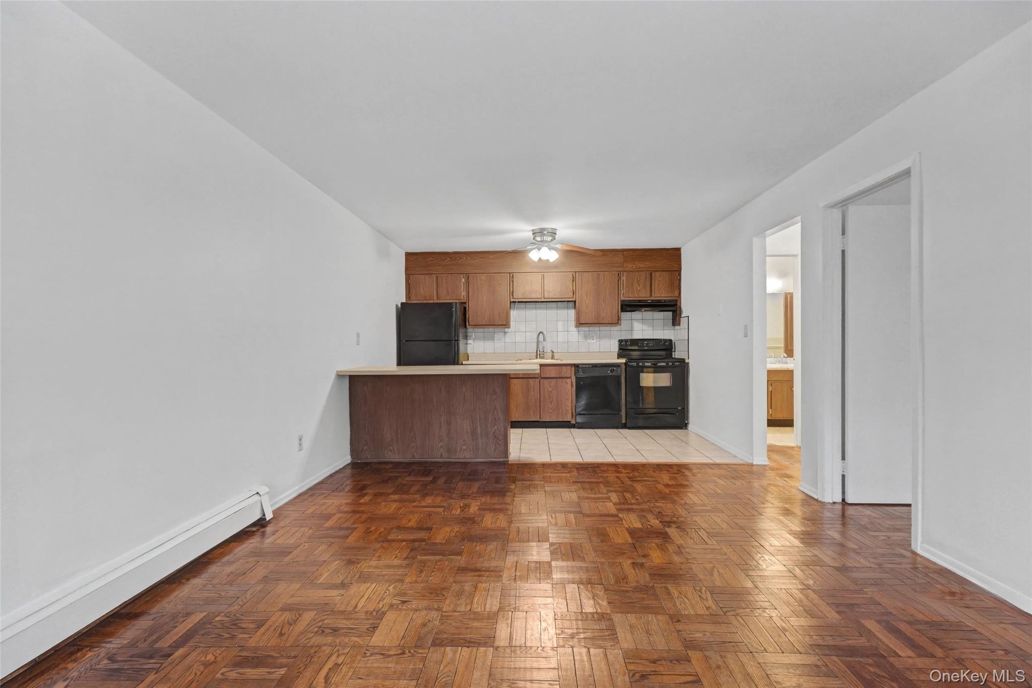 1840 Crompond Road, Unit 2A3 Peekskill, NY 10566 - Photo 5 of 22 a living room with stainless steel appliances kitchen island granite countertop a refrigerator and a sink
