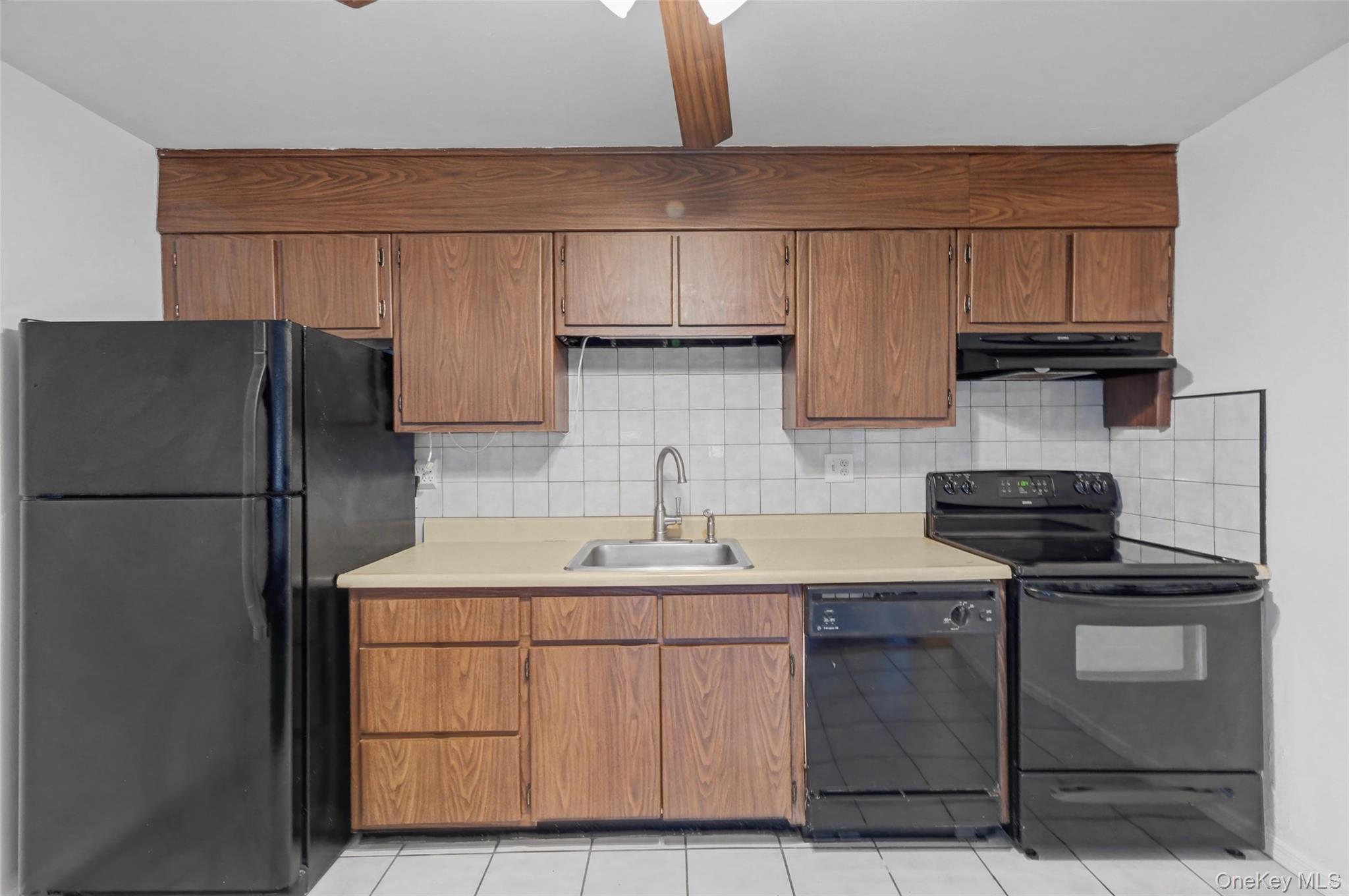 1840 Crompond Road, Unit 2A3 Peekskill, NY 10566 - Photo 9 of 22 a kitchen with stainless steel appliances granite countertop a sink stove and refrigerator