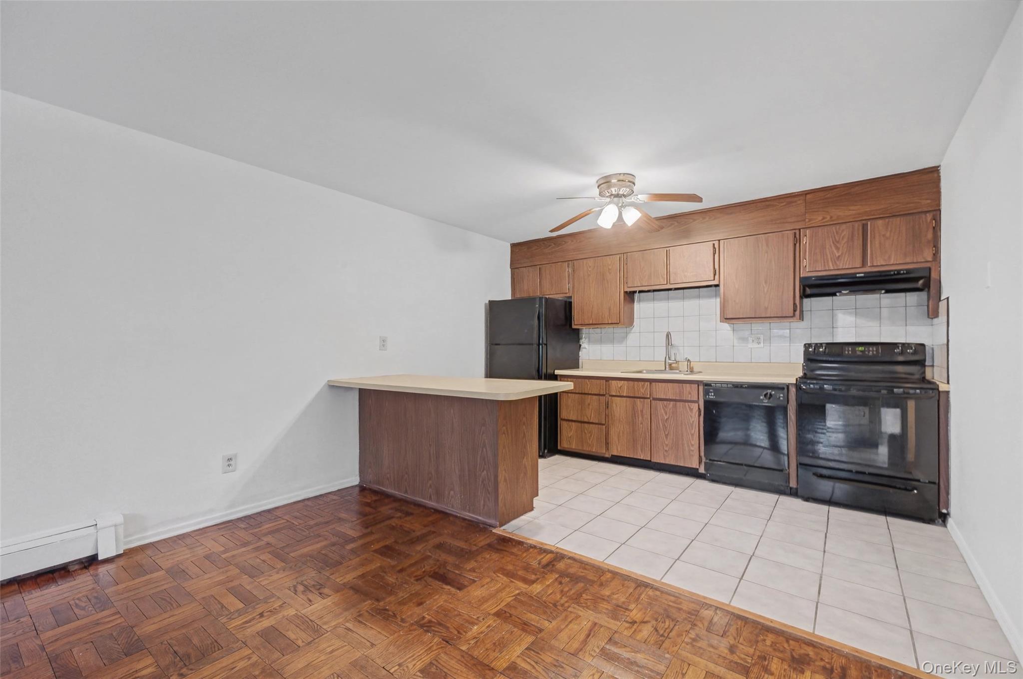 1840 Crompond Road, Unit 2A3 Peekskill, NY 10566 - Photo 10 of 22 a kitchen with stainless steel appliances granite countertop a stove a sink and a refrigerator