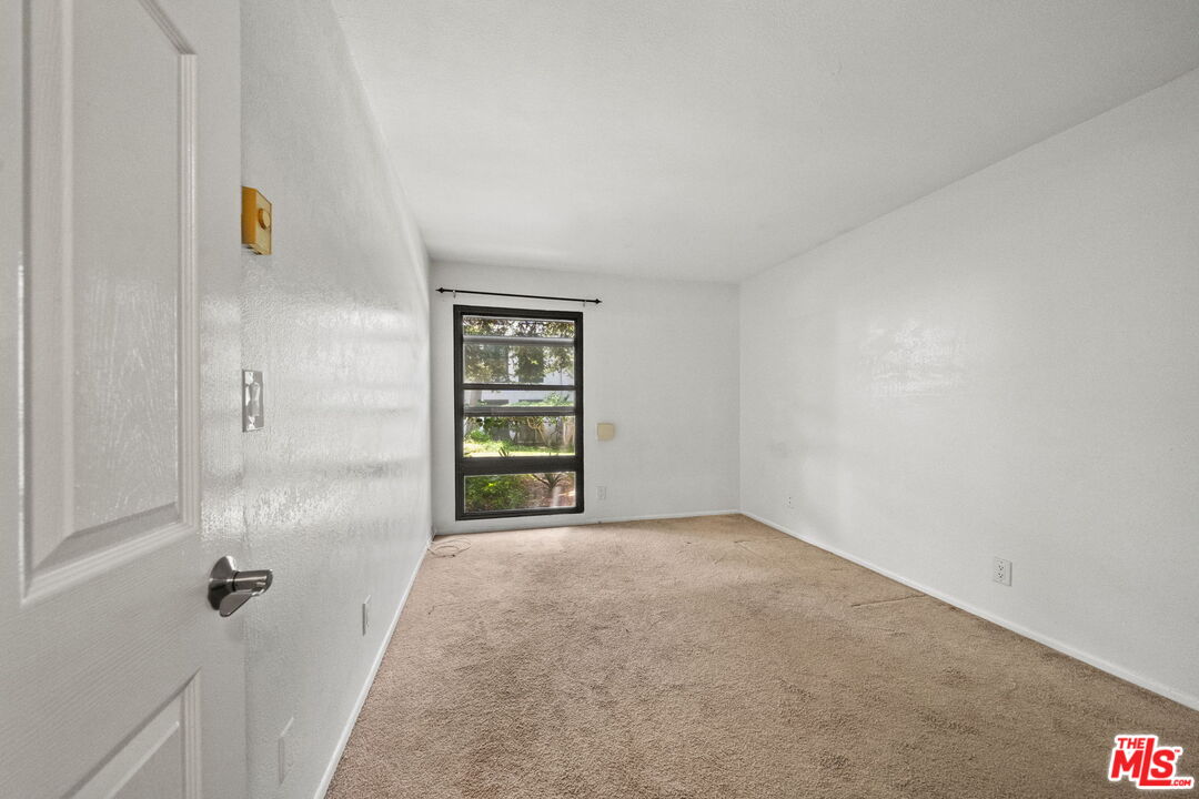 7765 West 91st Street, Unit F1110 Playa del Rey, CA 90293 - Photo 14 of 22 an empty room with windows