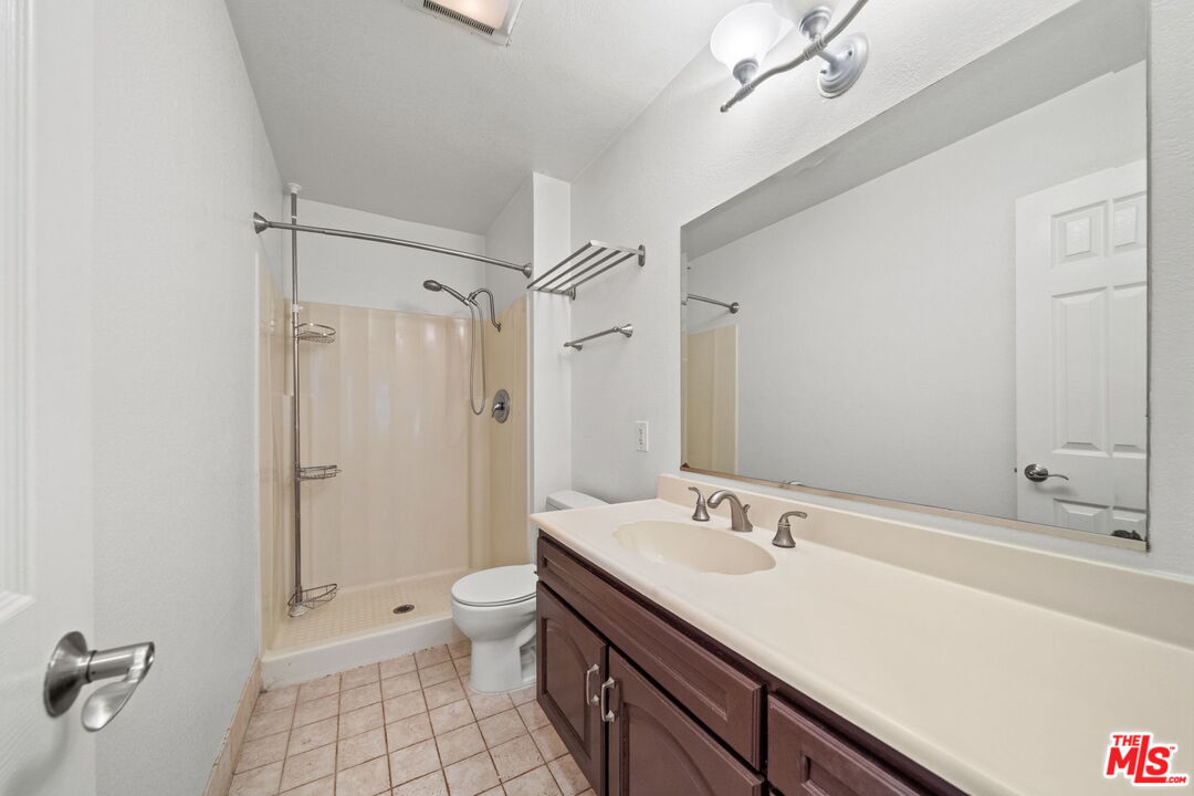 7765 West 91st Street, Unit F1110 Playa del Rey, CA 90293 - Photo 8 of 22 a bathroom with a sink a toilet a shower and a mirror