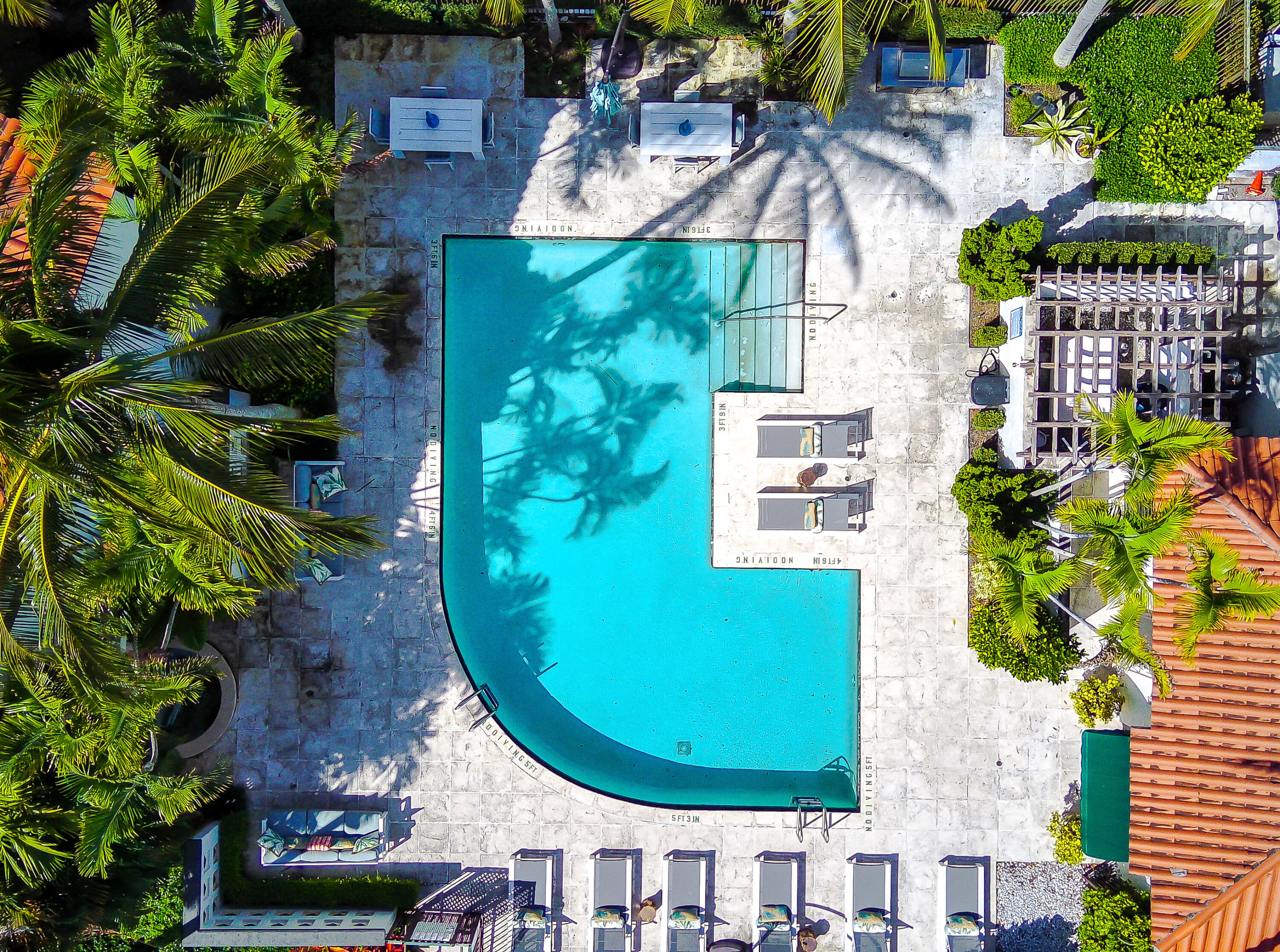 an aerial view of a house with a swimming pool