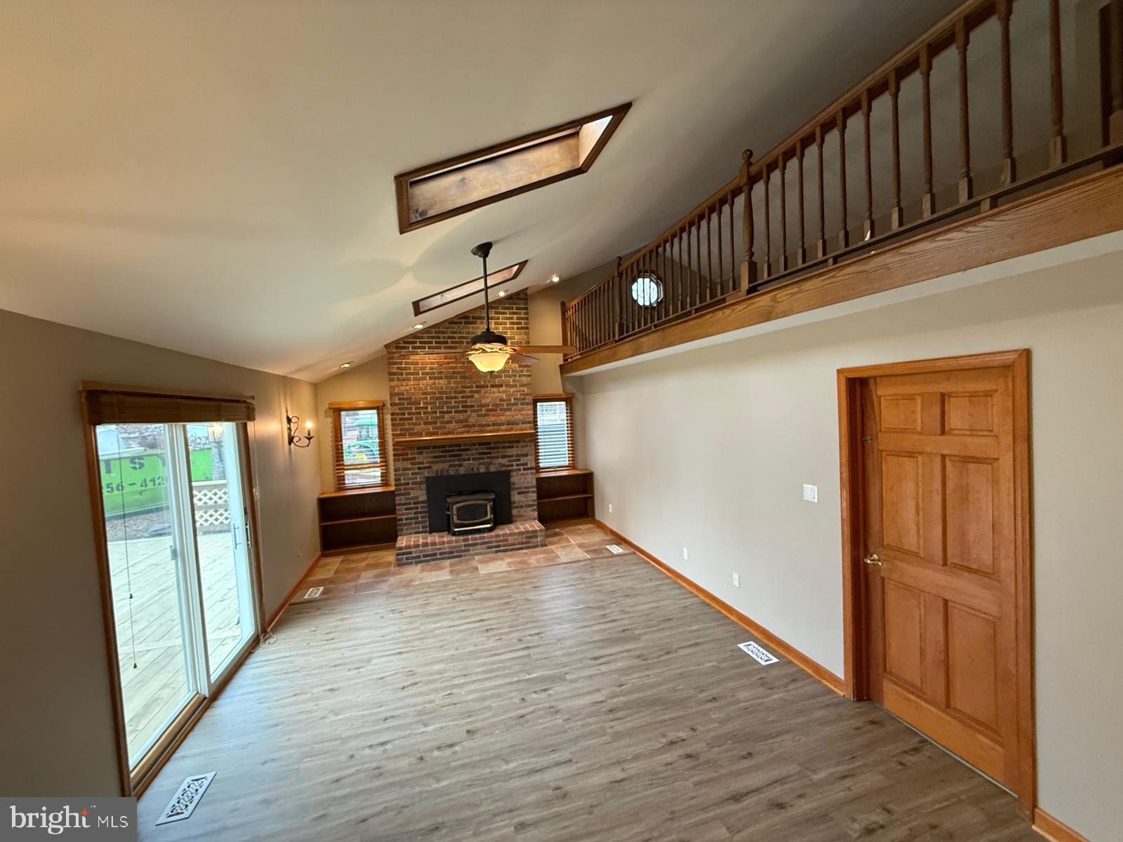620 Columbia Road Egg Harbor City, NJ 08215 - Photo 15 of 53 a view of an empty room with wooden floor fireplace and a window