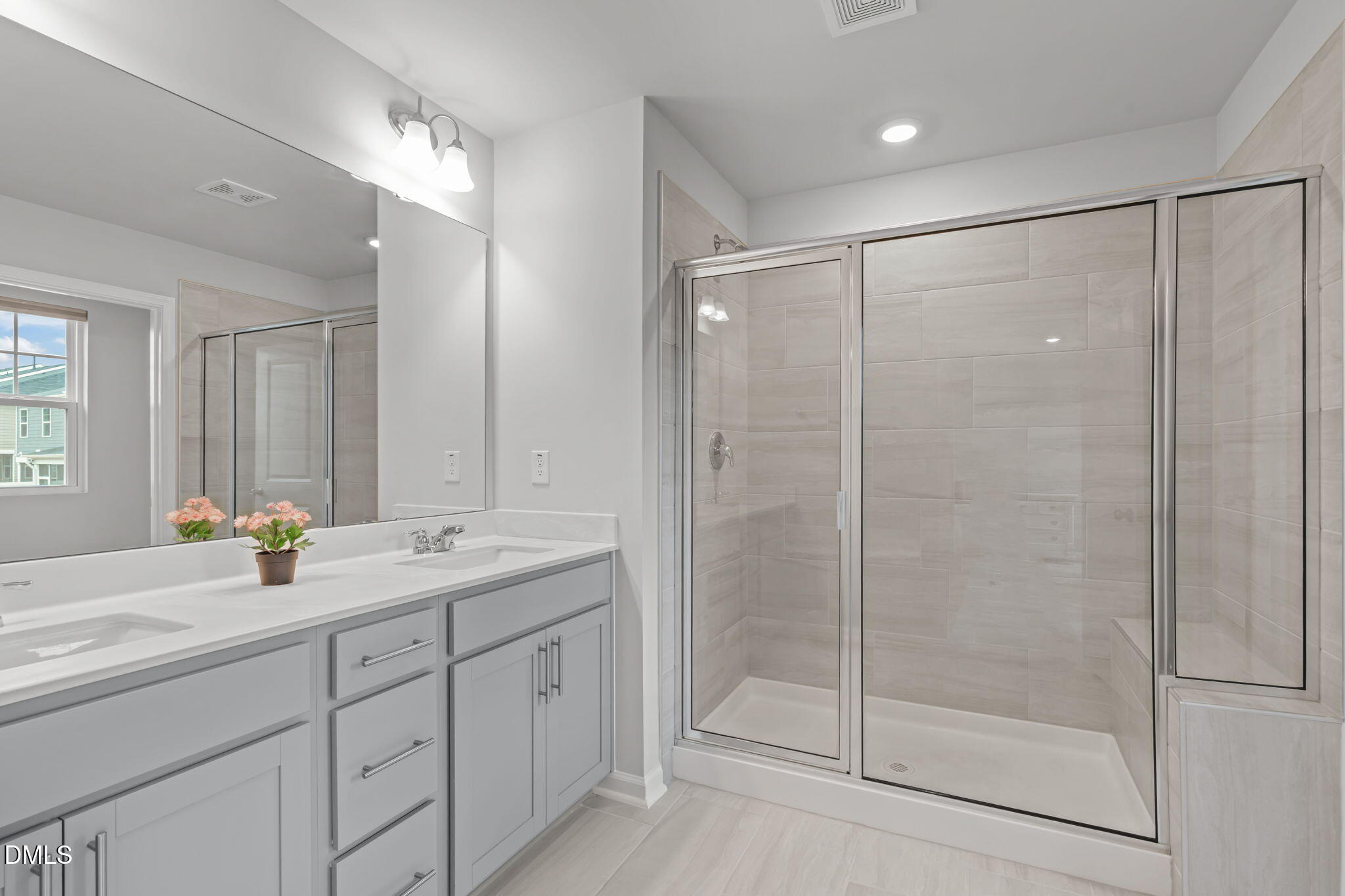 1809 Barrett Run Trail Apex, NC 27502 - Photo 22 of 37 a bathroom with a shower sink and mirror