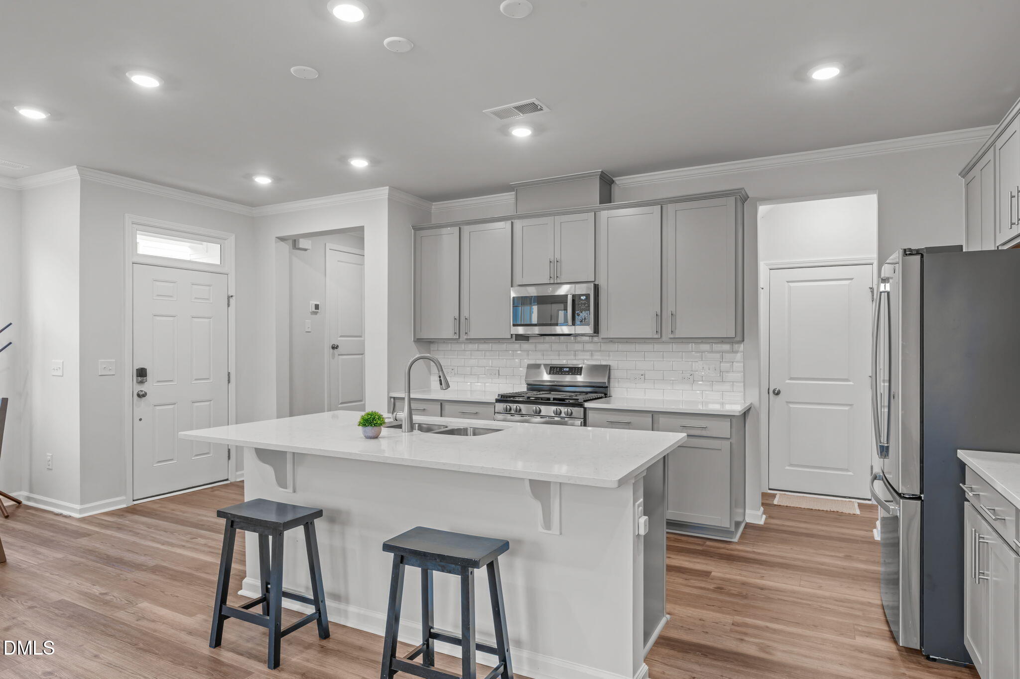 1809 Barrett Run Trail Apex, NC 27502 - Photo 9 of 37 a kitchen with a sink a refrigerator and wooden floor
