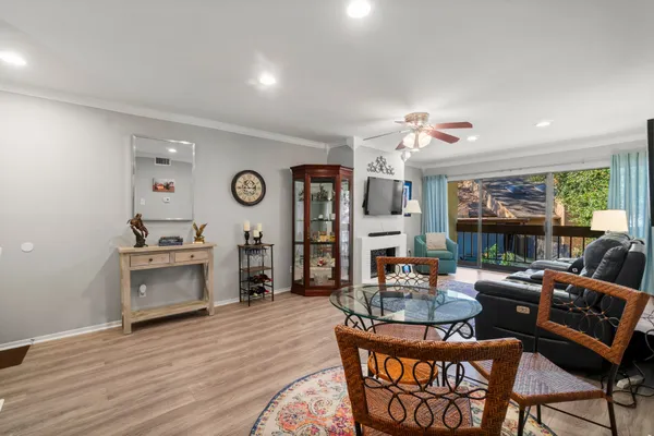 a living room with furniture a fireplace and a flat screen tv