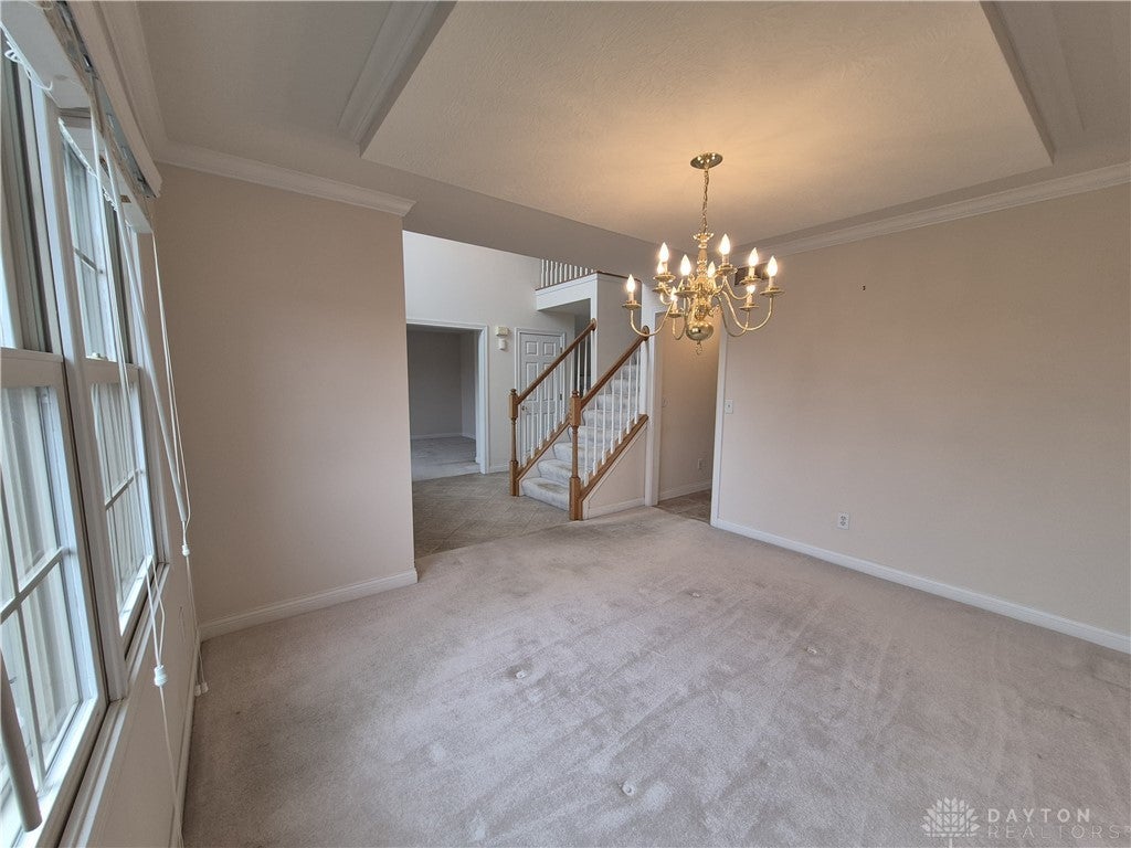 633 Orient Way Hamilton, OH 45013 - Photo 9 of 68 This inviting space features elegant crown molding and a chandelier, creating a welcoming atmosphere.