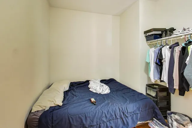 a bed room with a bed and a window