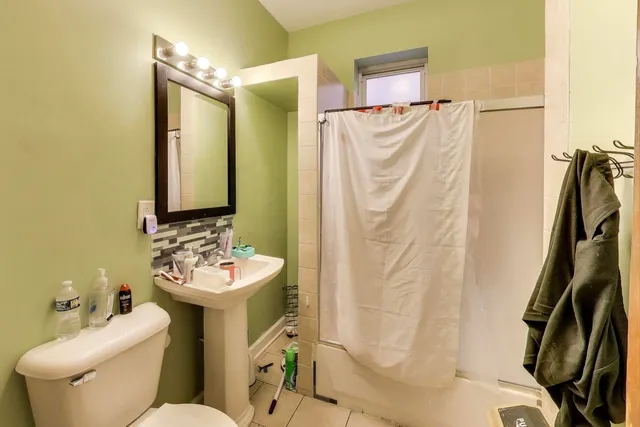 a living room with furniture a rug and gym equipment