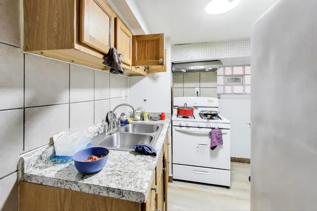 a bedroom with two beds and a dresser