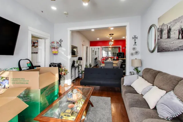 a living room with furniture and a flat screen tv