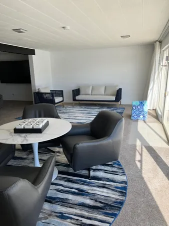 a kitchen with a refrigerator wooden floor a sink and a stove