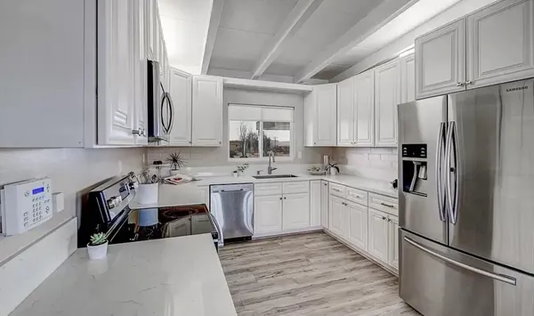 a bedroom with a large bed and a potted plant