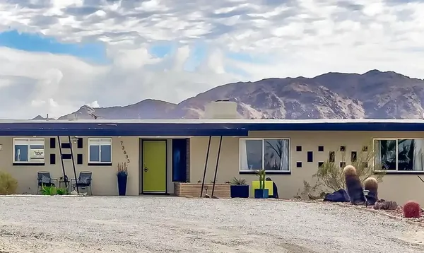 a view of a patio with table and chairs under an umbrella
