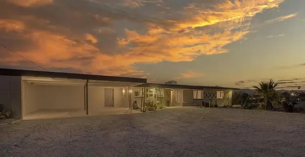 a view of a backyard with a patio and fire pit