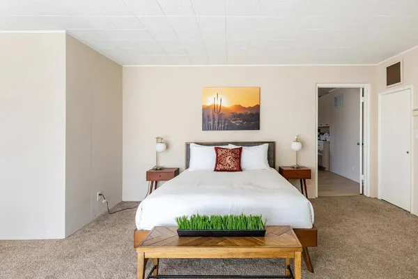a living room with furniture a rug and a window
