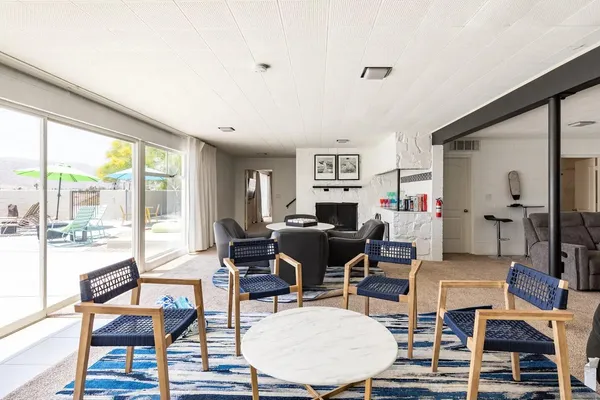 a bedroom with a bed and large window