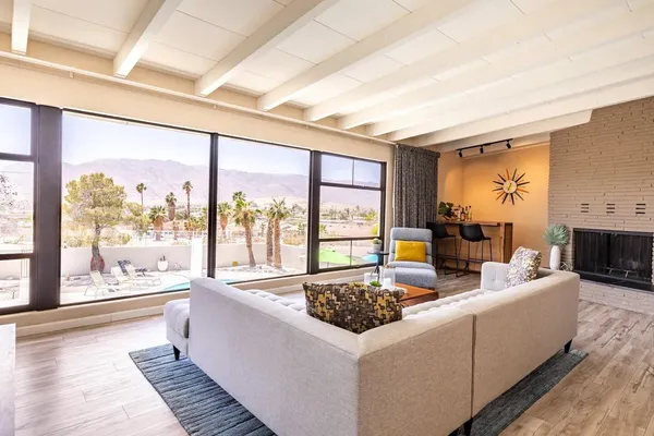 a dining room with table chairs and a chandelier