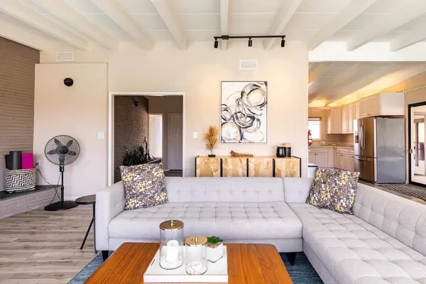 a living room with furniture and a floor to ceiling window