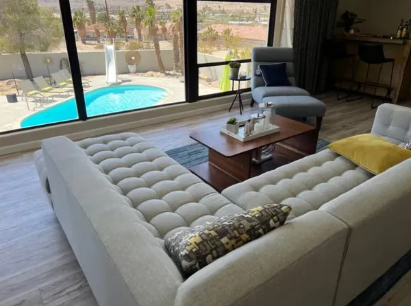 a view of a livingroom with furniture and a large window