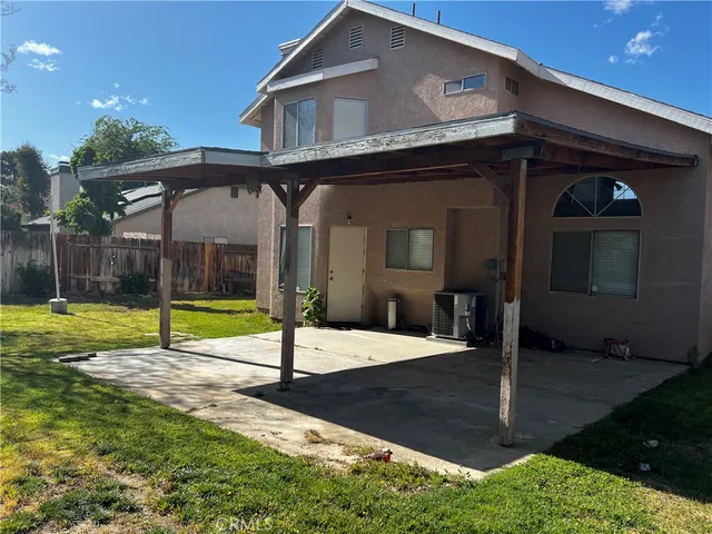 a view of a house with swimming pool and yard