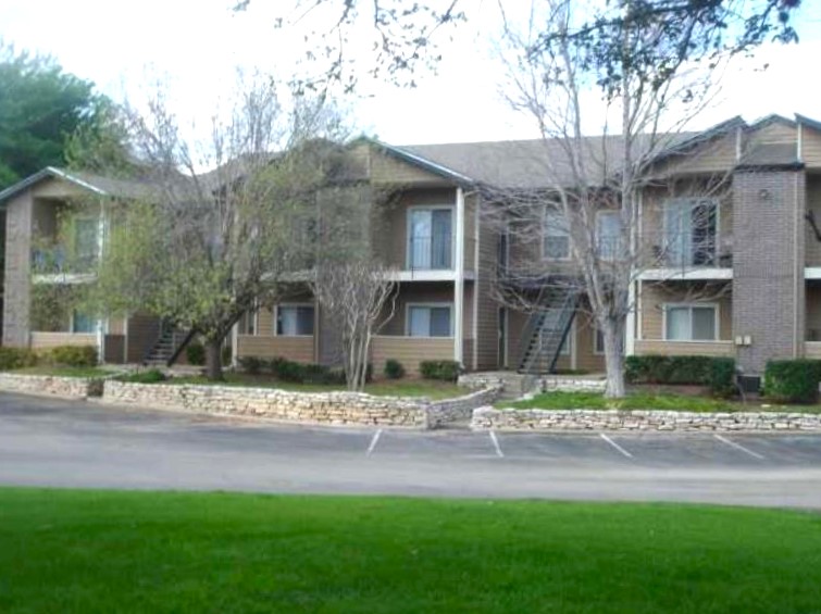 12166 Metric Boulevard, Unit 339 Austin, TX 78758 - Photo 1 of 13 a front view of a house with a yard and green space