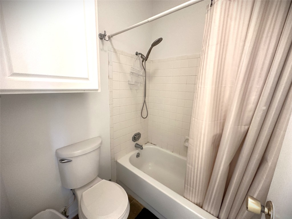 12166 Metric Boulevard, Unit 339 Austin, TX 78758 - Photo 10 of 13 a bathroom with a toilet and a bathtub
