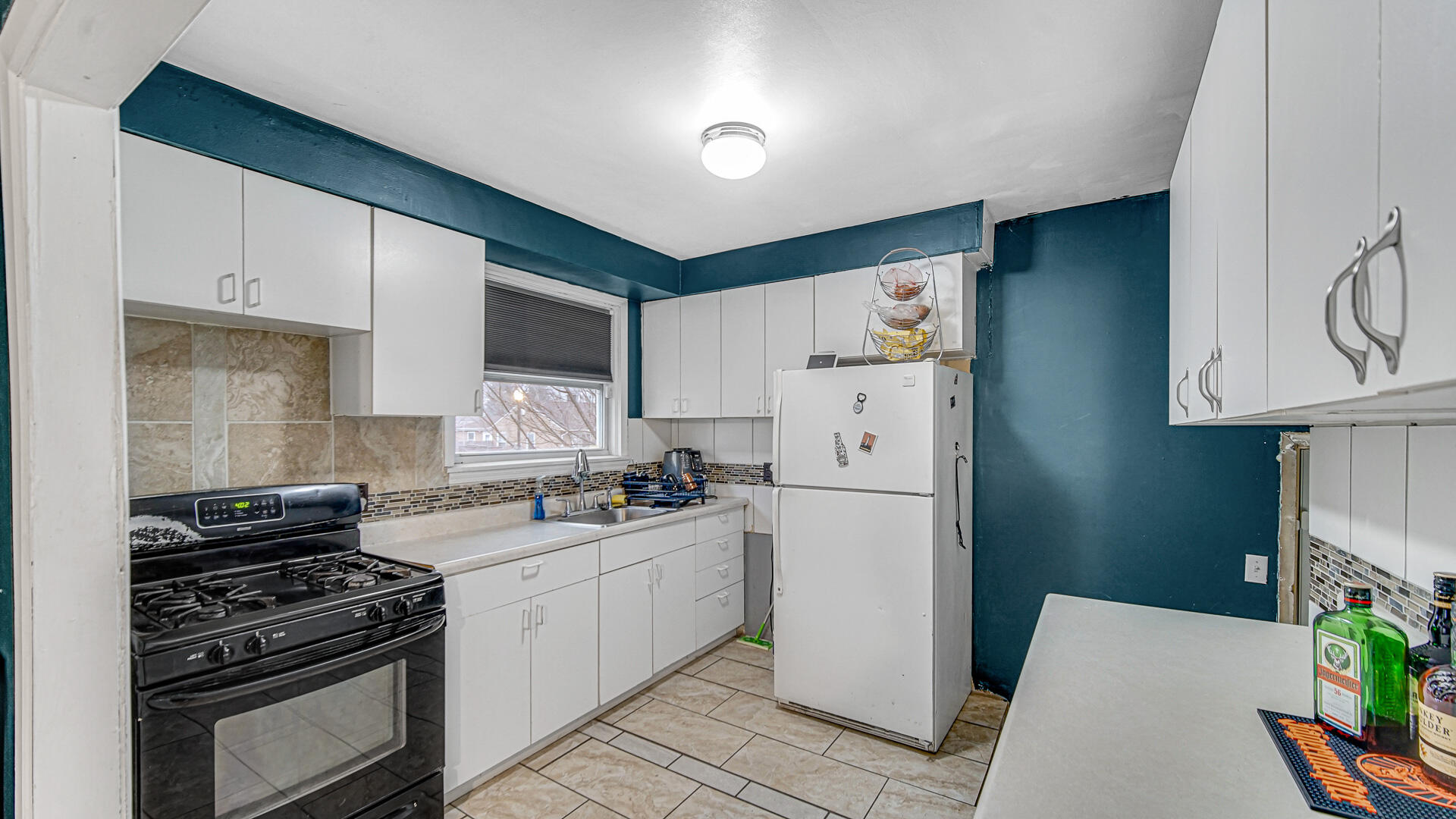 631 141st Street Hammond, IN 46327 - Photo 5 of 24 a kitchen with a stove a refrigerator and a sink