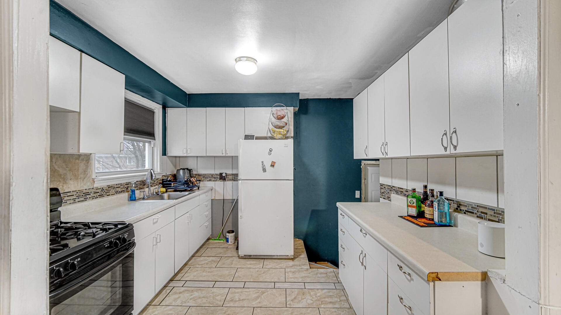 631 141st Street Hammond, IN 46327 - Photo 6 of 24 a kitchen with a sink a stove and refrigerator