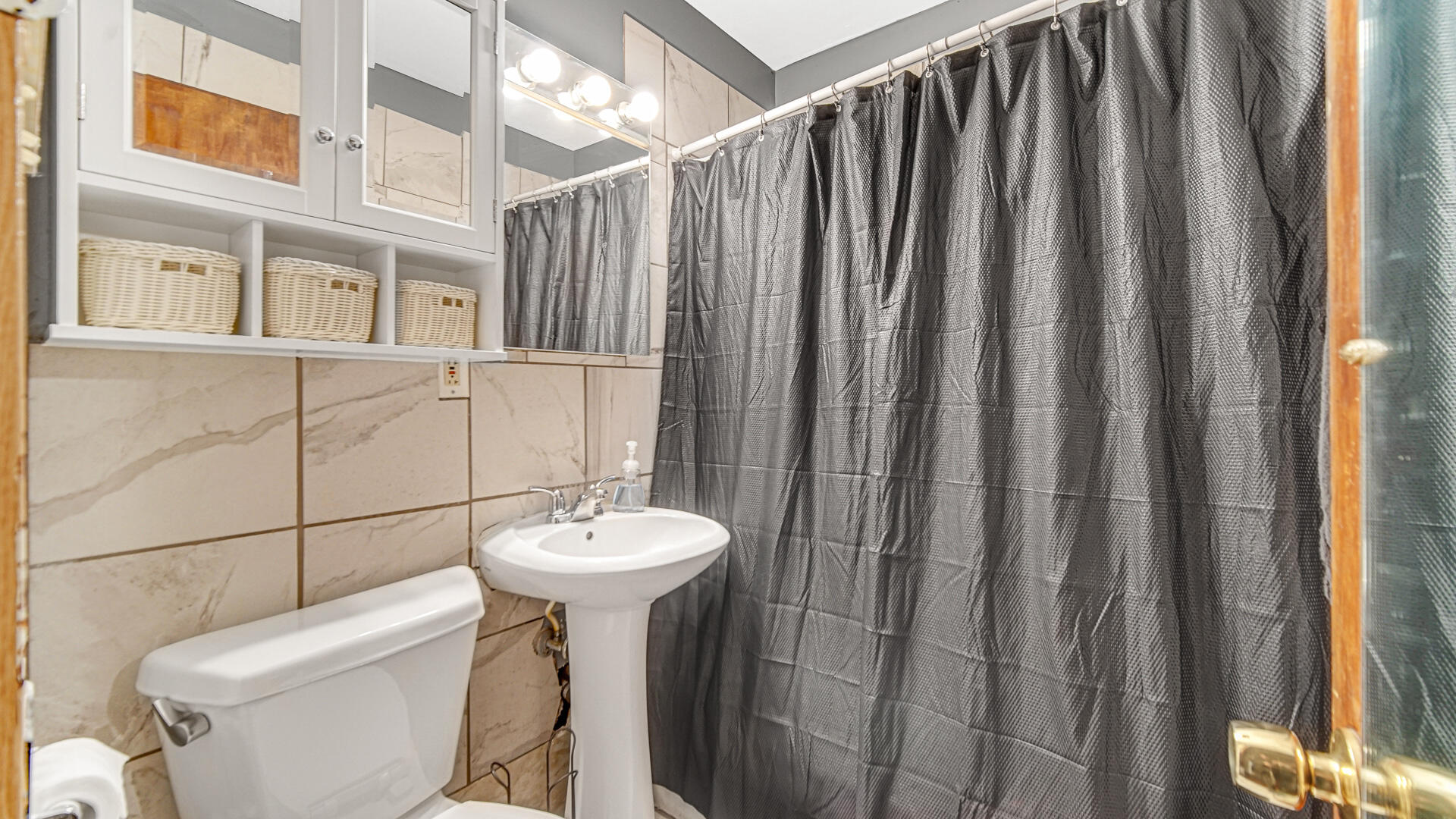 631 141st Street Hammond, IN 46327 - Photo 7 of 24 a bathroom with a sink a toilet a mirror and shower curtain