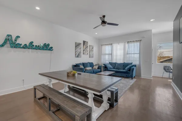 a living room with furniture and wooden floor