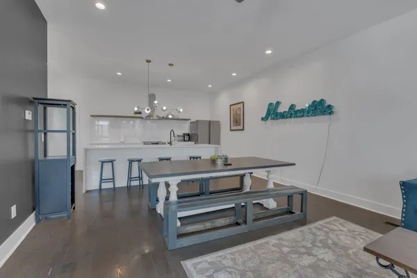a view of a kitchen with kitchen island stainless steel appliances a stove and wooden floor
