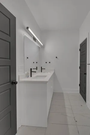 a bathroom with a sink a mirror and a shower