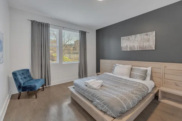 a bedroom with a bed and chair