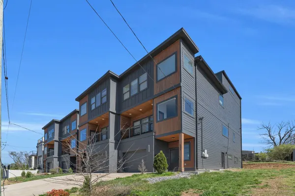 a front view of a building with a yard