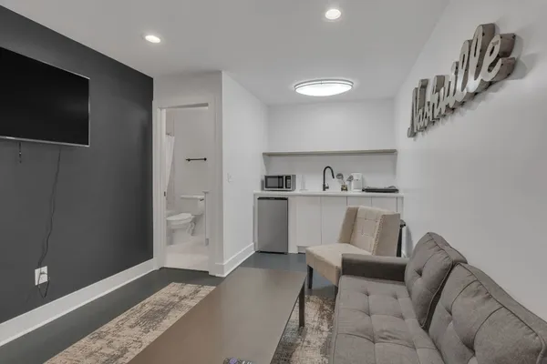 a living room with furniture and a flat screen tv