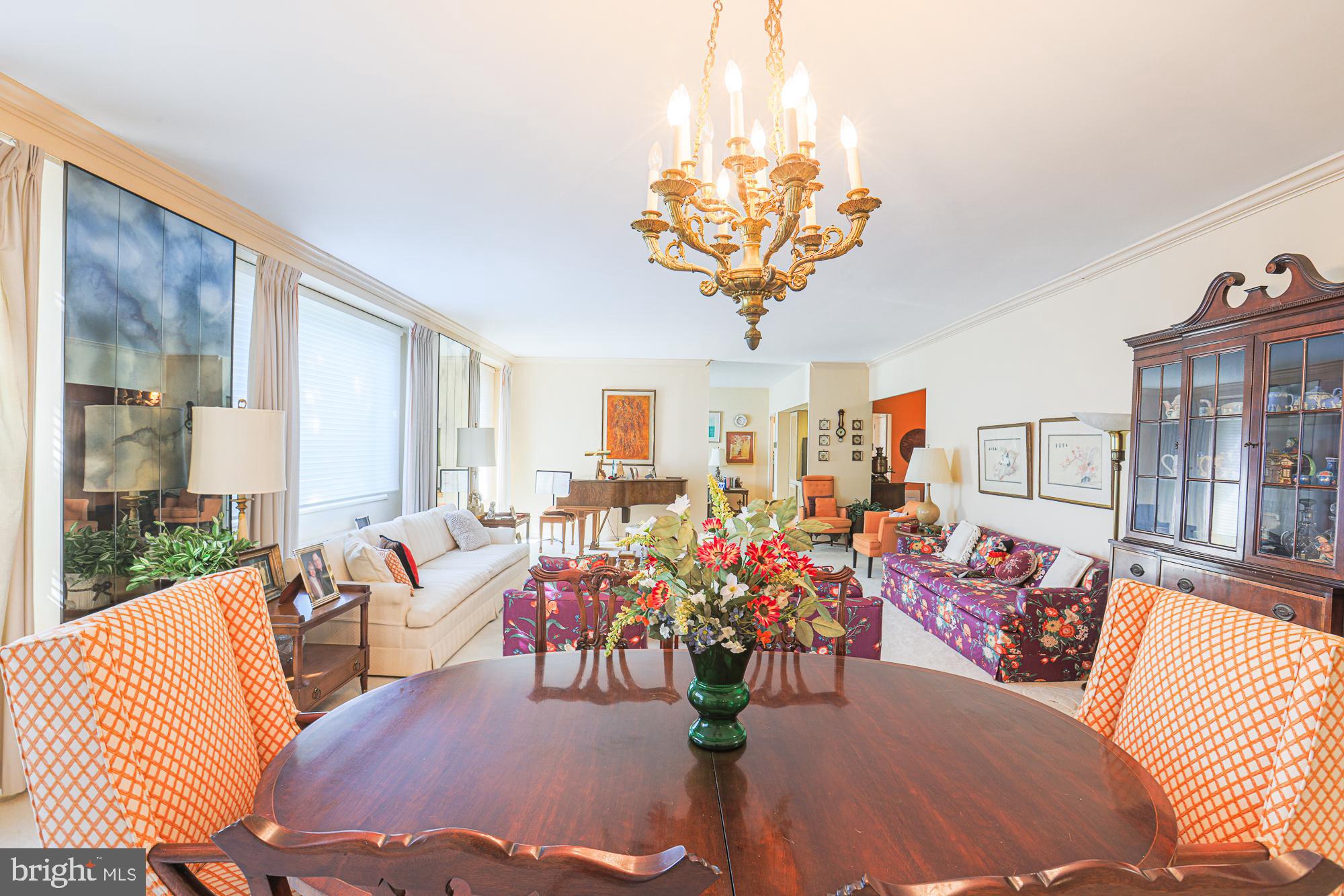 a view of a dining room with furniture wooden floor and chandelier