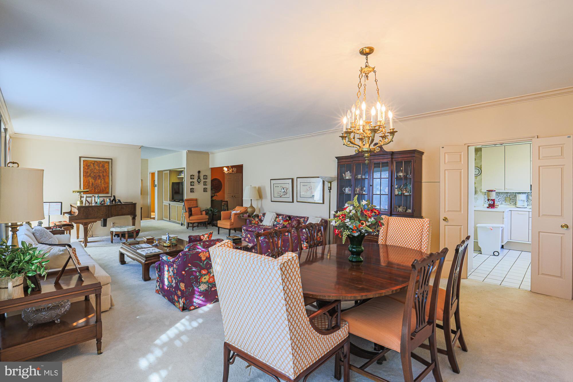 11 Slade Avenue, Unit 412 Baltimore, MD 21208 - Photo 16 of 37 a dining room with furniture a chandelier and window