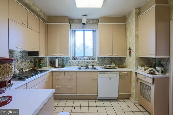 a kitchen with a stove sink and cabinets
