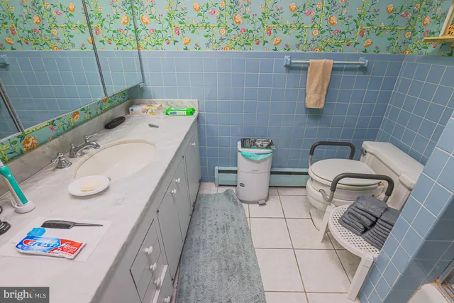 a bathroom with a sink mirror vanity and toilet