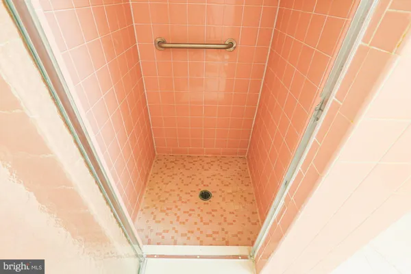 a view of walk in closet with clothes