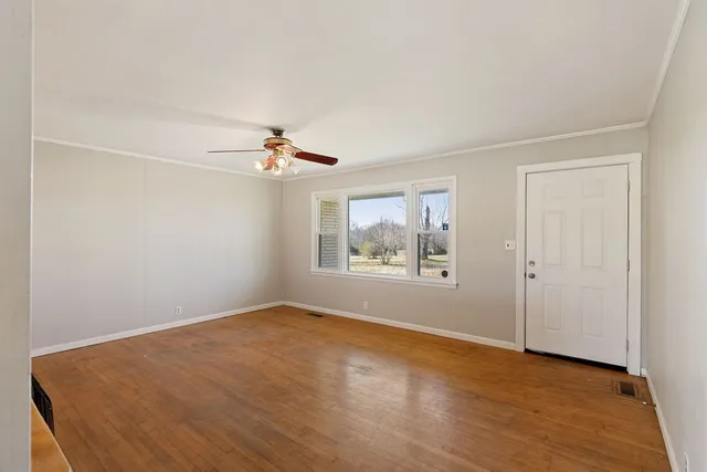 wooden floor in an empty room with a window