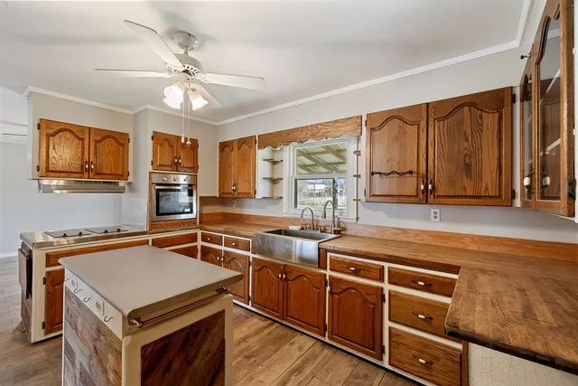 a kitchen with stainless steel appliances a stove sink and cabinets