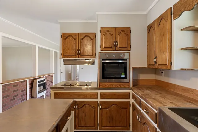 a kitchen with stainless steel appliances granite countertop a stove and a refrigerator