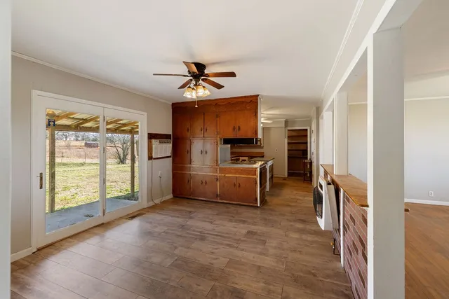a view of a kitchen with a sink and refrigerator