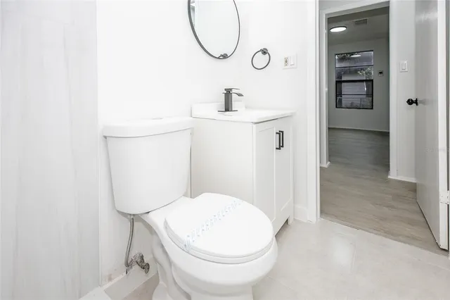 a bathroom with a toilet sink and shower