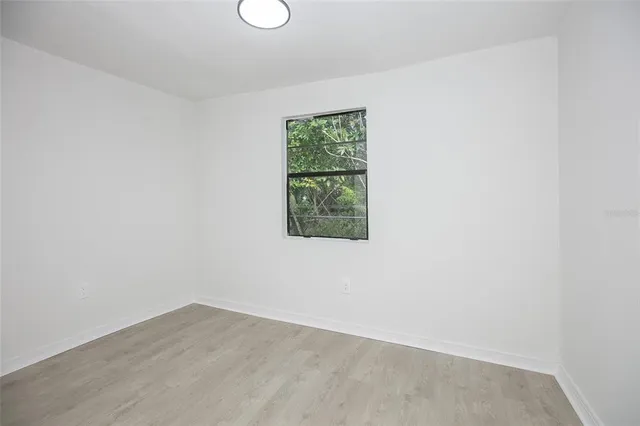 a view of a small space with wooden floor and windows