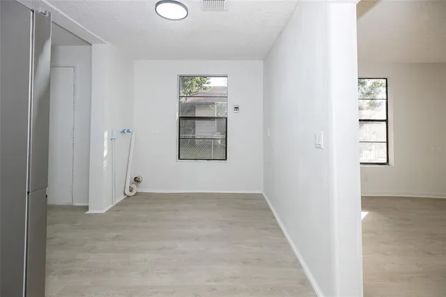 an empty room with windows and closet