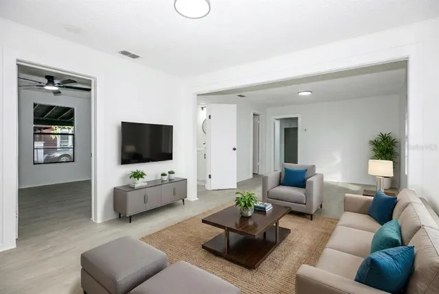 a living room with furniture and a flat screen tv