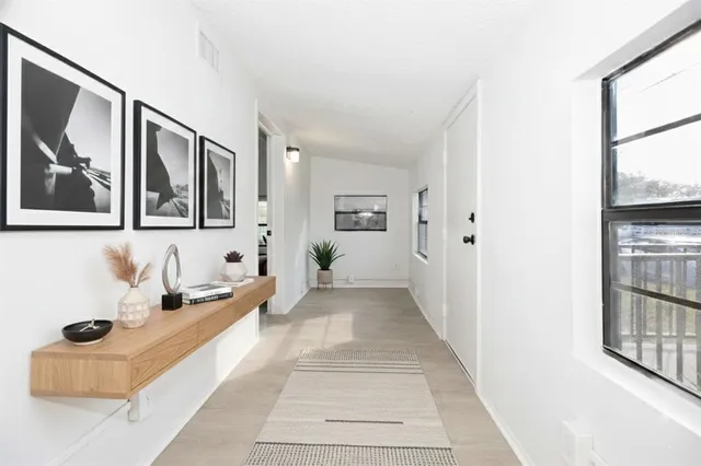 a hallway with furniture and window